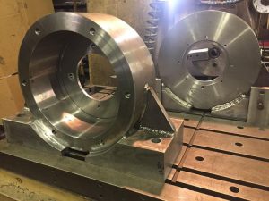 Metal machinery parts on a workbench.